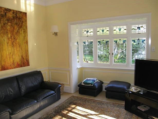 A nicely decorated living room with bay window.